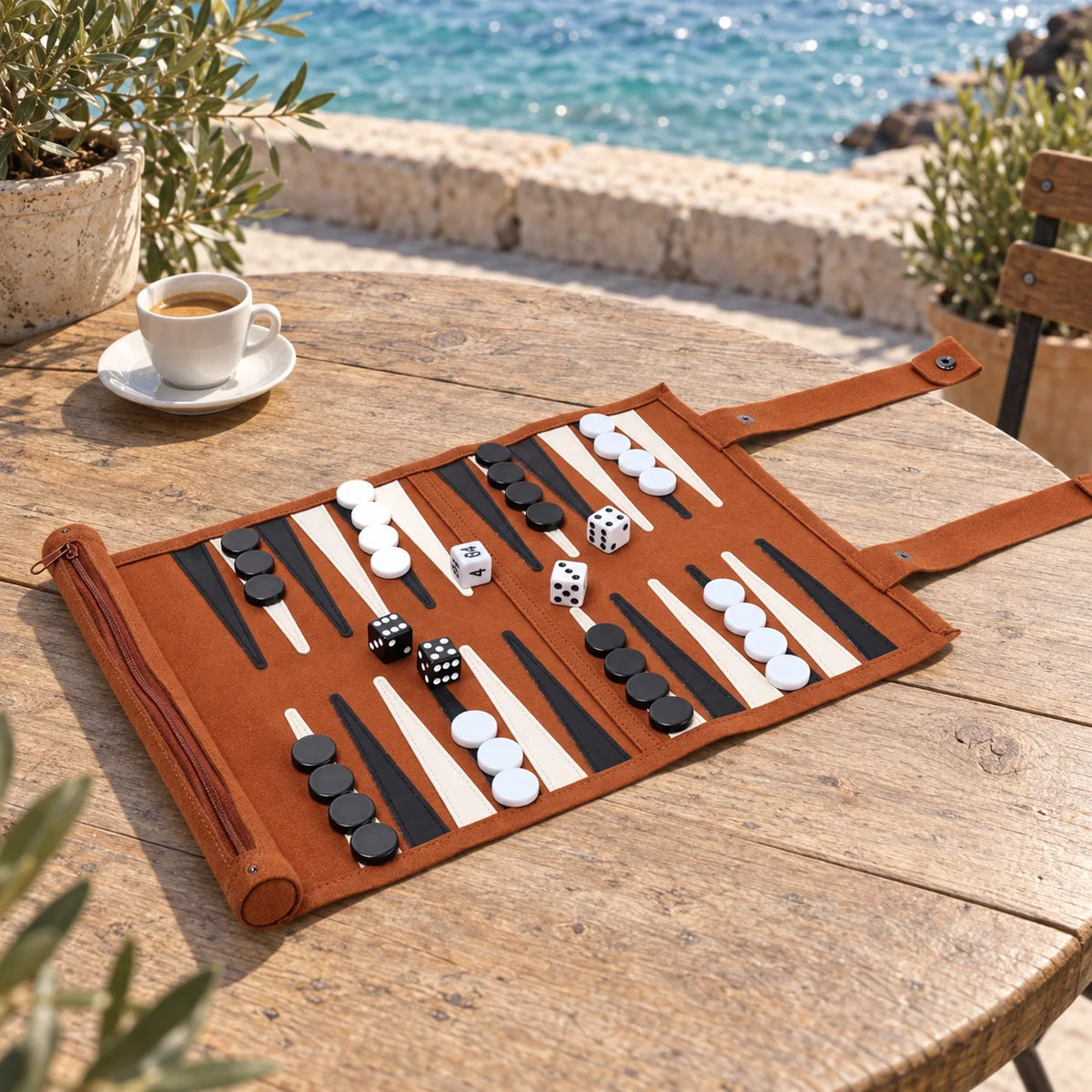 Travel backgammon on a sunny outdoor seaside café table