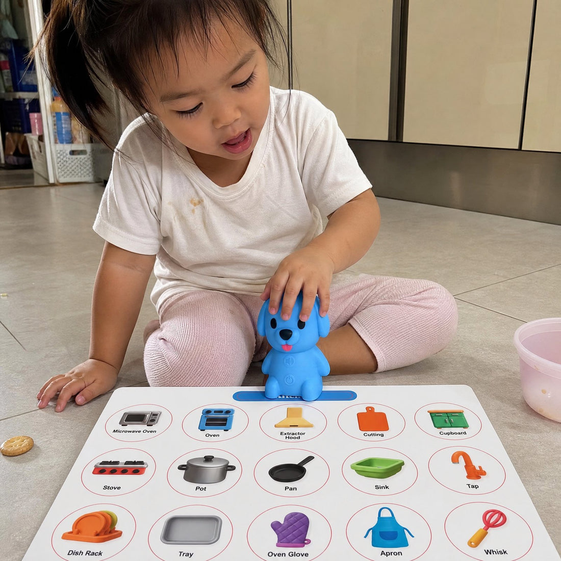 A child exploring a room board with the Puppy Reader