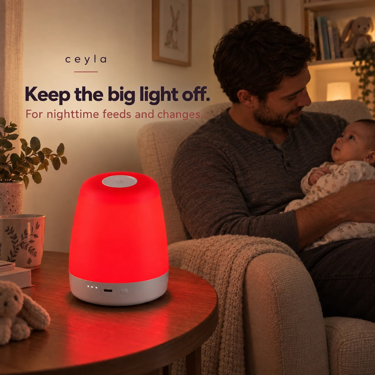 NightNest on an adult side table while a father holds his awake baby. For nighttime feeds and changes.