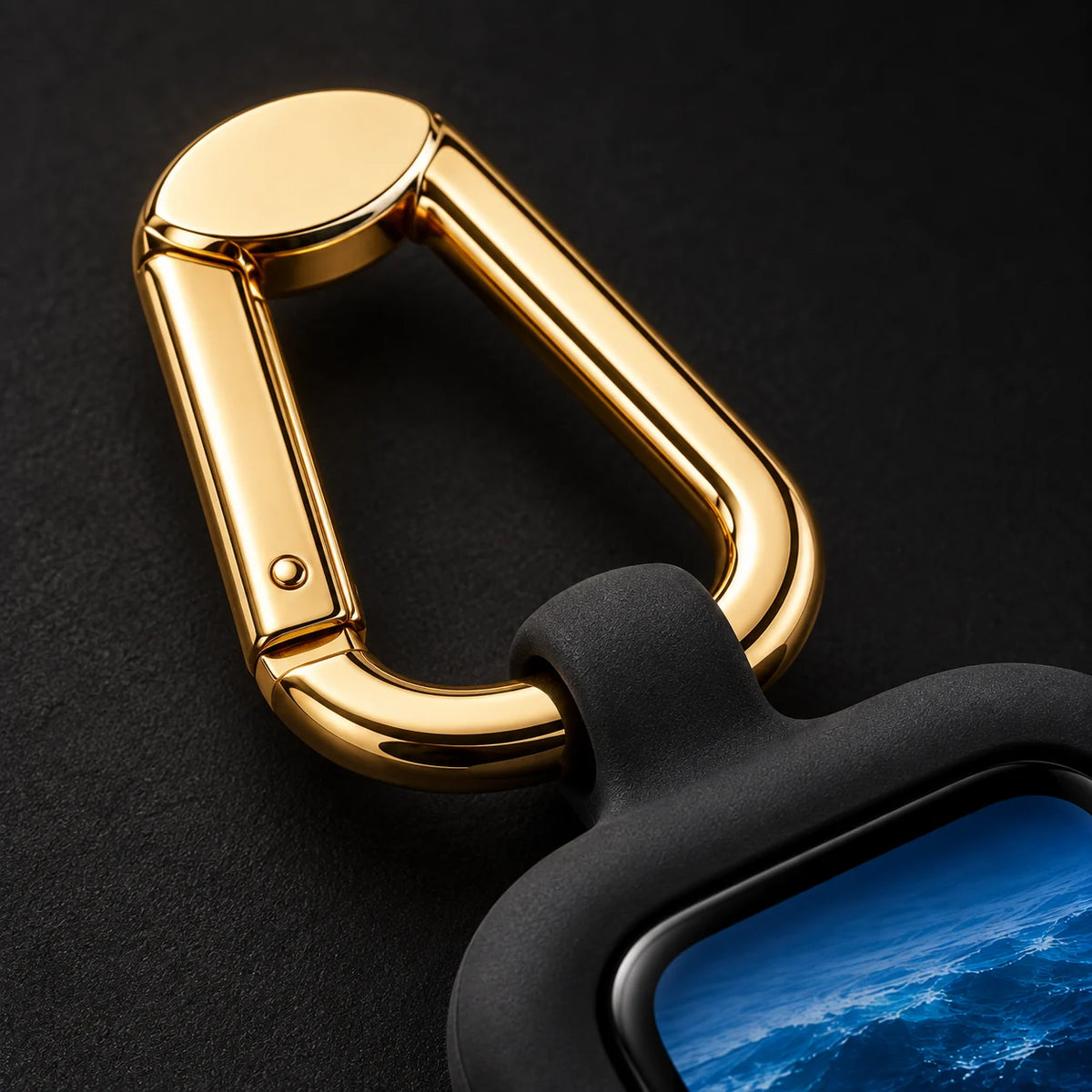 A close-up of ReLoop’s gold-tone carabiner clip and its short integrated silicone connection.