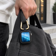 ReLoop clipped to a bag handle during everyday carry. Watch and bag not included.