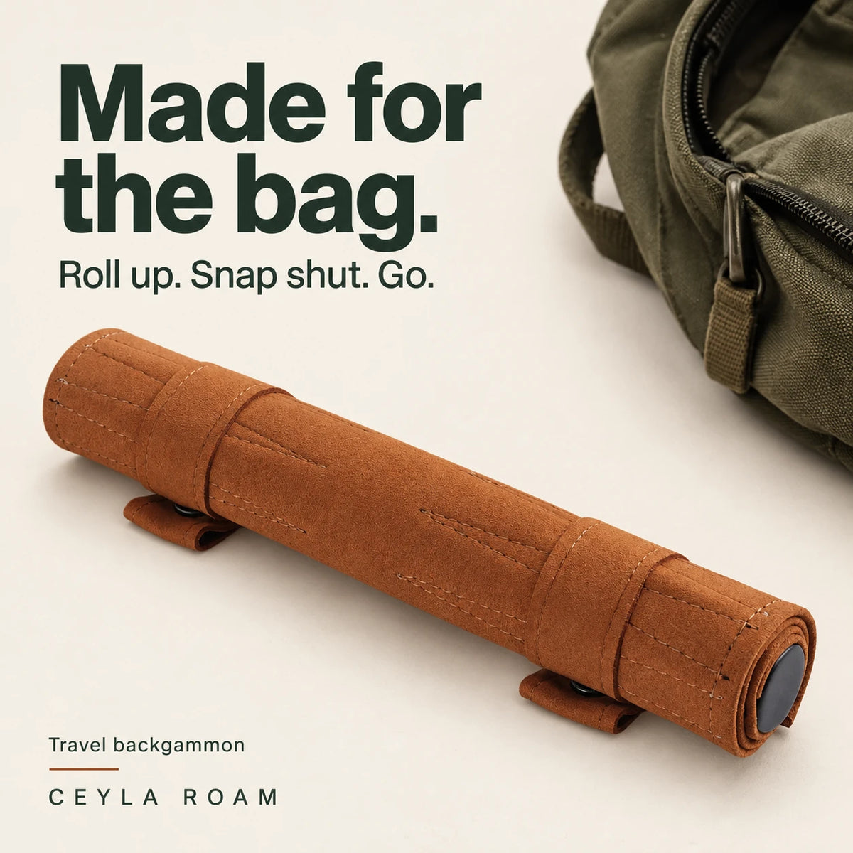 Made for the bag. Cognac travel backgammon rolled and secured with two snap straps beside a daypack.
