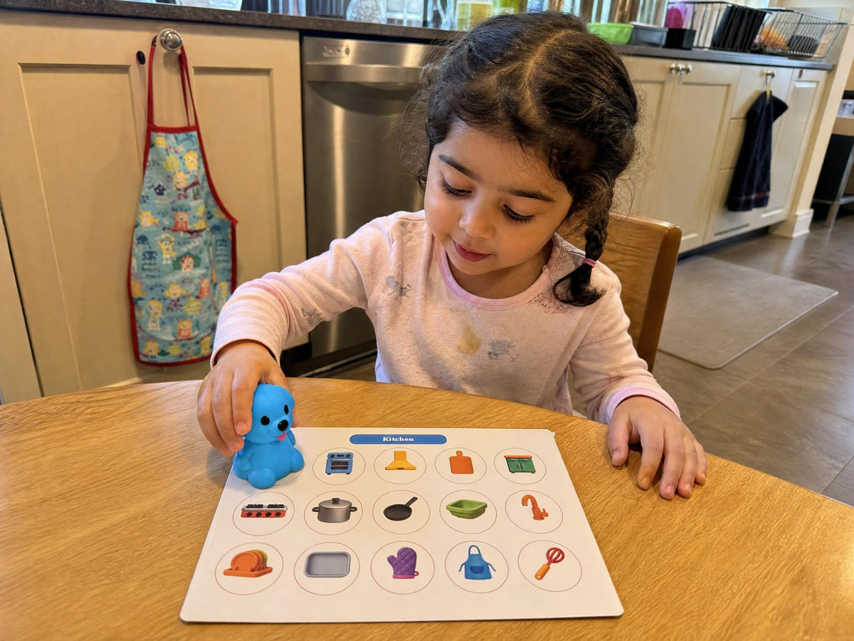 A child exploring the Ceyla Puppy Reader Kitchen board in a matching home setting