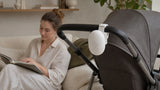 Ceyla Sway attached to a stroller handle with a parent sitting nearby