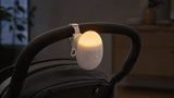 Sway’s warm dome light glowing on a stroller handle
