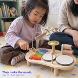 A child actively exploring the music station with adult supervision; ages 1 to 8