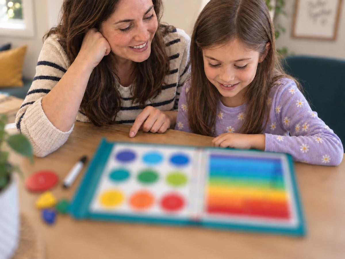 Parent and child using the magnetic fraction book together